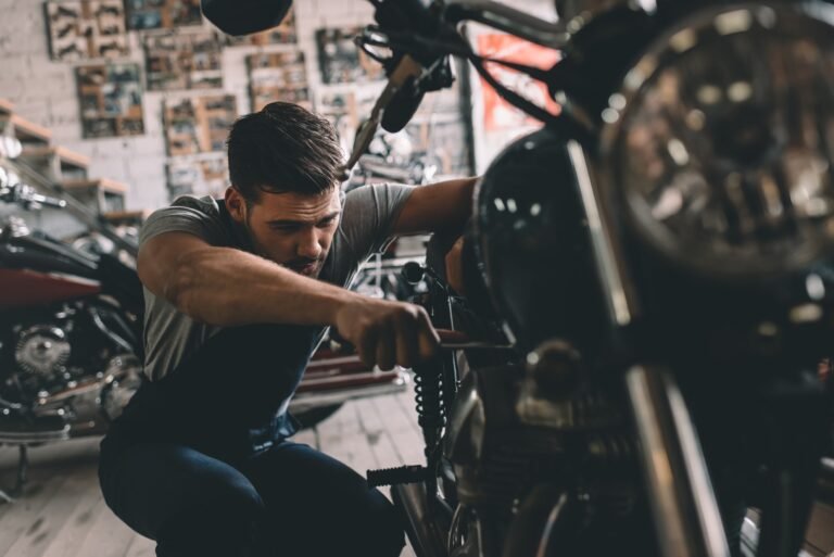 young-handsome-automechanic-repairing-motorbike